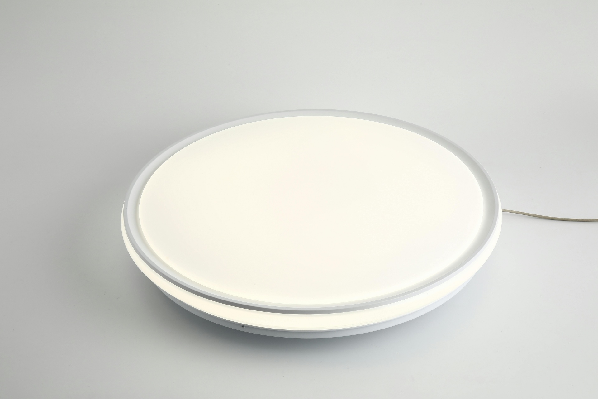 Sleek round LED ceiling light fixture with minimalistic design on a neutral white background.