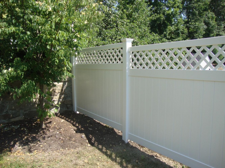 a vinyl fence can be a good way to block unsightly views with creative landscaping